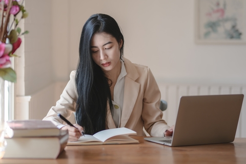 Girl working at office taking notes