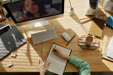 person writing at desk