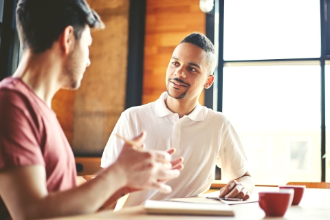 Two people looking at each other and talking